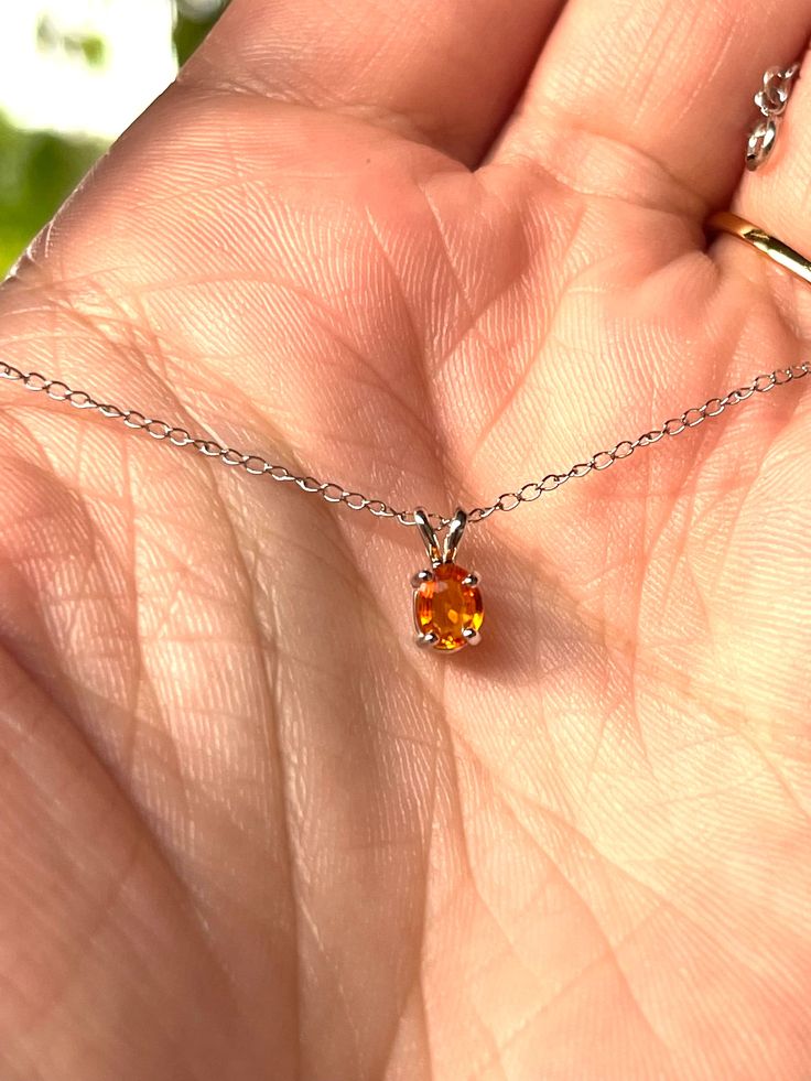 "I was fortunate to find only a few of these as loose stones and made them into beautiful pieces that are one-of-a-kind and well under a price that you typical retailers would sell them for. It'll make a unique and extravagant gift for that one (or two) lucky person(s). Description: -- Natural padparadscha (corundum)half carat sapphire in 14k solid white gold 18\" chain. -- Natural Genuine Padparadscha Sapphire, 5x4mm, Oval Cut, Orange Sapphire, Rare Sri Lanka, limited supplies, 0.5ct -- 14K Sol