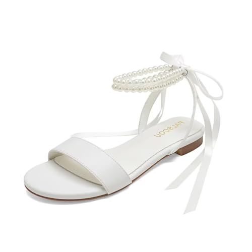 a white sandal with pearls on the ankle