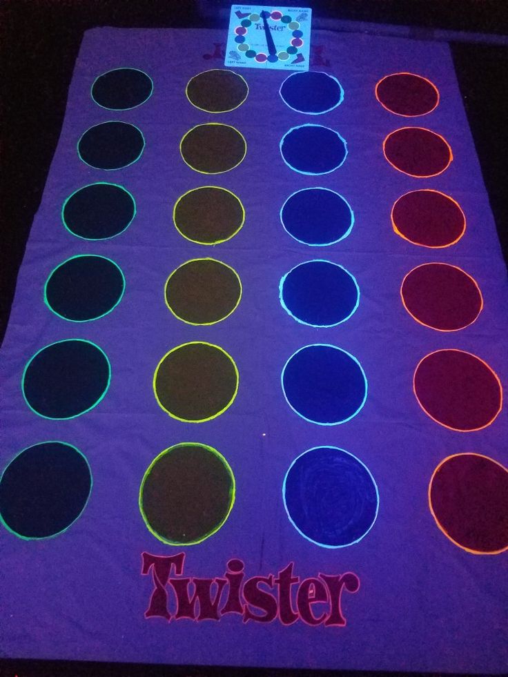 an illuminated dance mat with circles and numbers on it that spell out the word twister