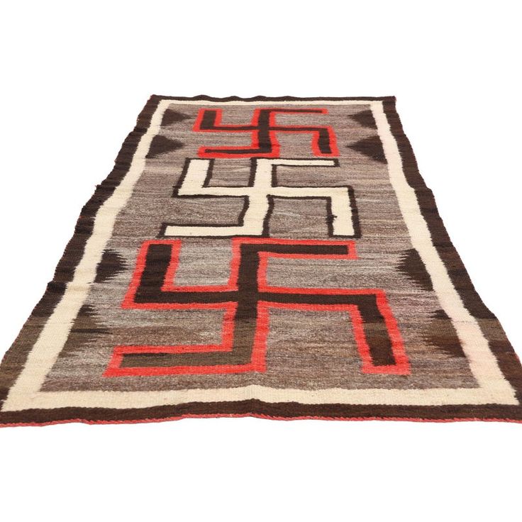 78928 Antique Crystal Whirling Log Navajo-Style Rug, 03'04 x 07'10. This exquisite handwoven wool Crystal Navajo-style rug embodies the rich cultural heritage and artistry of the Navajo people, showcasing the distinctive Whirling Log motif that has captivated collectors and connoisseurs of Native American textiles for over a century. The rug's harmonious blend of earthy tones—ranging from deep brown and soft gray to the striking contrast of red and beige—speaks to the weaver's skill in creating a visually dynamic yet balanced composition. At the heart of this piece is the Whirling Log, a sacred symbol of movement, life, and good fortune, repeated in rhythmic patterns that evoke a sense of continuity and harmony with nature.  The Whirling Log motif, which predates its appropriation in other Rhythmic Pattern, Red And Beige, Navajo Style, Harmony With Nature, Sacred Symbols, Deep Brown, Cultural Heritage, Earthy Tones, Rug Styles