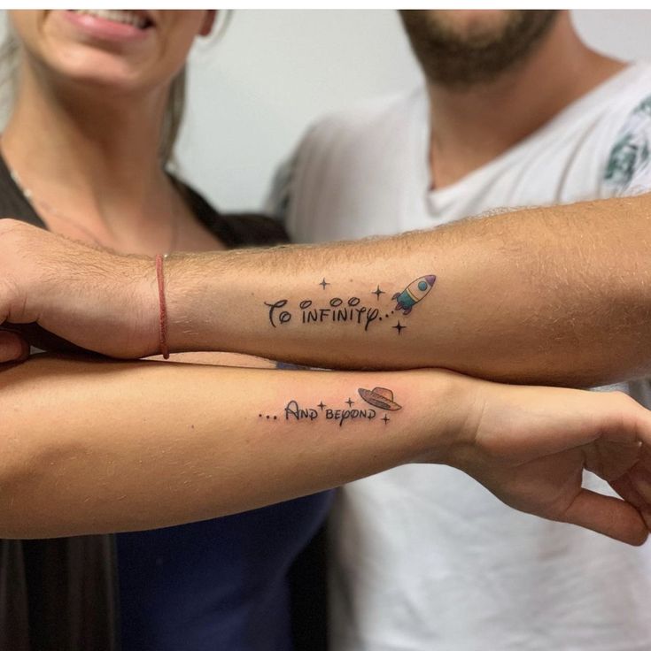 two people with matching tattoos on their arms