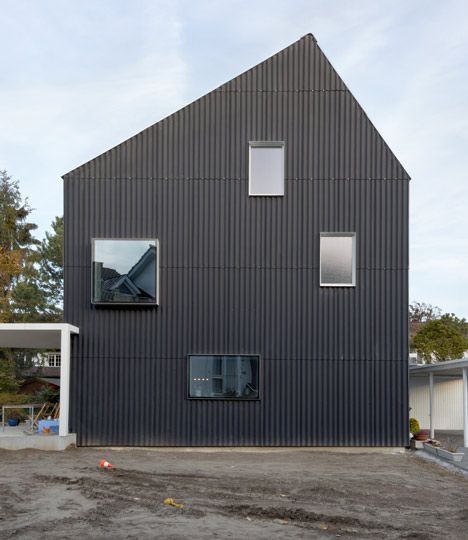 a black house with three windows on the side