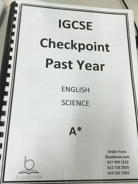 an iggse checkpoint point past year book is on the table next to a computer mouse