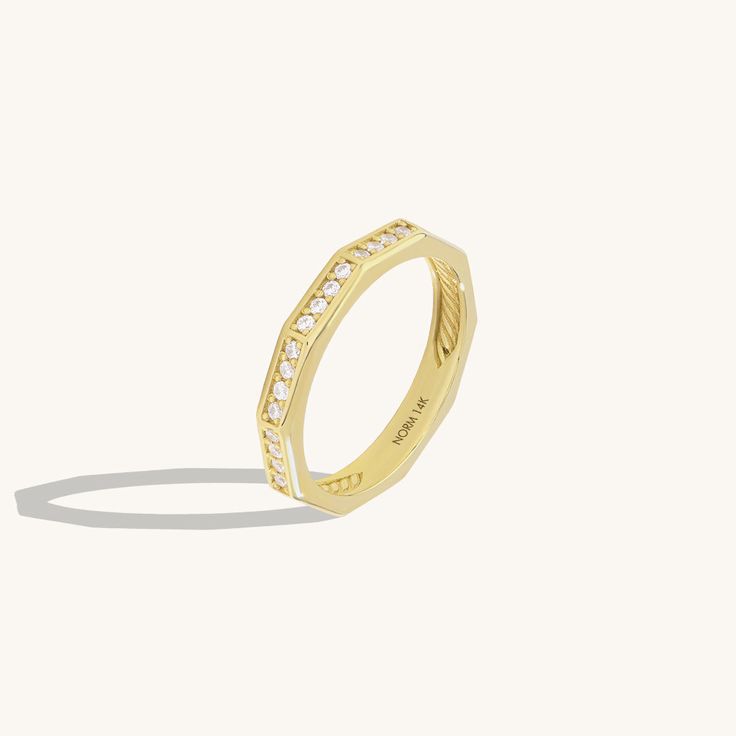 Elevate your hand with our Faceted Eternity Ring. This exquisite design radiates timeless beauty with its intricate design. The faceted surfaces reflect light brilliantly, creating a mesmerizing sparkle that symbolizes eternal love and elegance. Whether worn as a symbol of commitment or as a dazzling statement piece, this ring adds a touch of sophistication to any look. - Made in 14k solid gold - Decorated with handset white cubic zirconia stone on 14k solid gold - Band Width: 2.85 mm / 0.11 inc Elegant Emerald-cut Stackable Diamond Rings, Luxury Baguette Cut Stackable Promise Rings, Elegant Emerald Cut Diamond Stackable Rings, Luxury White Gold Eternity Band With Halo Design, Elegant Octagon Halo Design Jewelry, Elegant Octagon Halo Jewelry, Elegant Asscher Cut Eternity Band With Vvs Clarity, Luxury Diamond Stackable Rings With Diamond Cut, Timeless Stackable Promise Rings