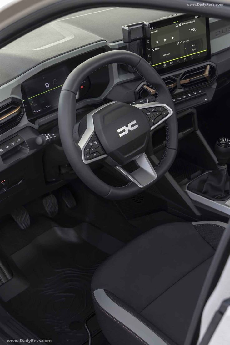 the interior of a car with steering wheel, dashboard and infotains on display