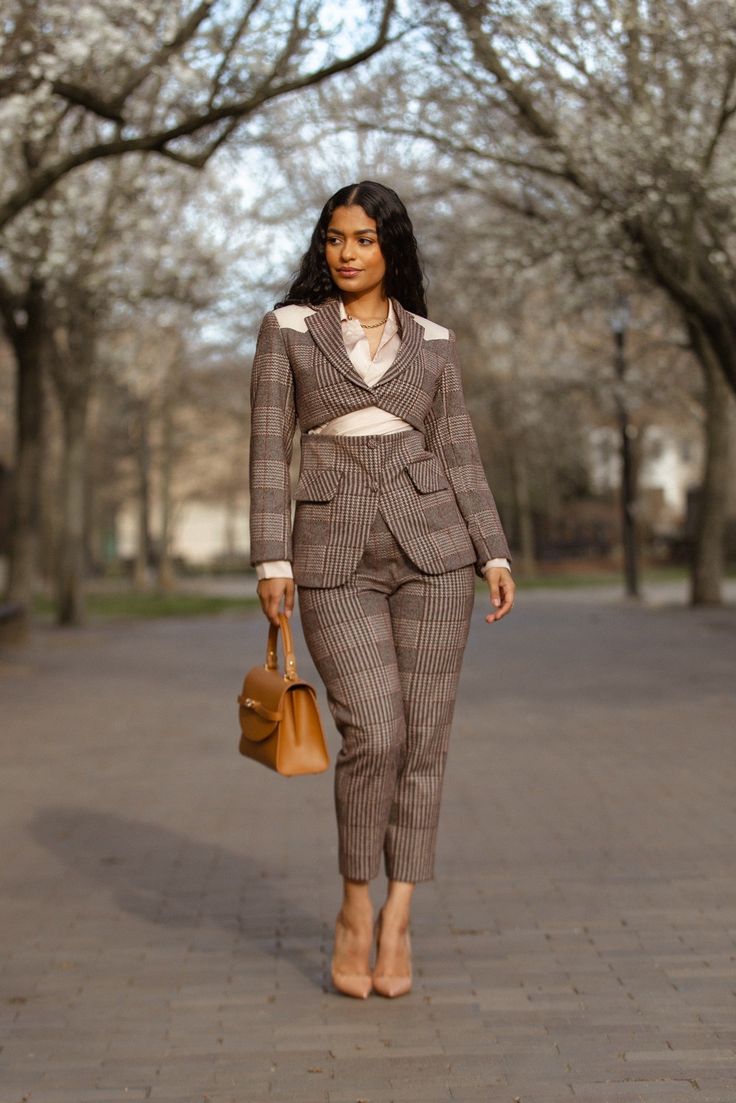 This Structured Plaid Suit Set is the perfect choice for a professional or formal look. Crafted with a deconstructed cut blazer, it features a detailed leather patch on the shoulder and sleeve and boasts a single button closure and a decorative flap pocket for added style. Features a high waist ankle-length pants with zip and metal hook closure on the side. The pants has pockets on both sides. Model is 5ft 4in and she is wearing UK size 6/XS Note - Olarsgrace uses UK sizing format. Tailored Plaid Blazer For Semi-formal Occasions, Semi-formal Fall Plaid Suit, Fall Semi-formal Plaid Suit, Plaid Tailored Tweed Jacket For Semi-formal Occasions, Plaid Suit For Business Casual In Fall, Plaid Business Casual Fall Suit, Fall Office Suit With Houndstooth Pattern, Business Casual Suits With Suit Collar For Fall, Plaid Lapel Collar Suits For Business Casual