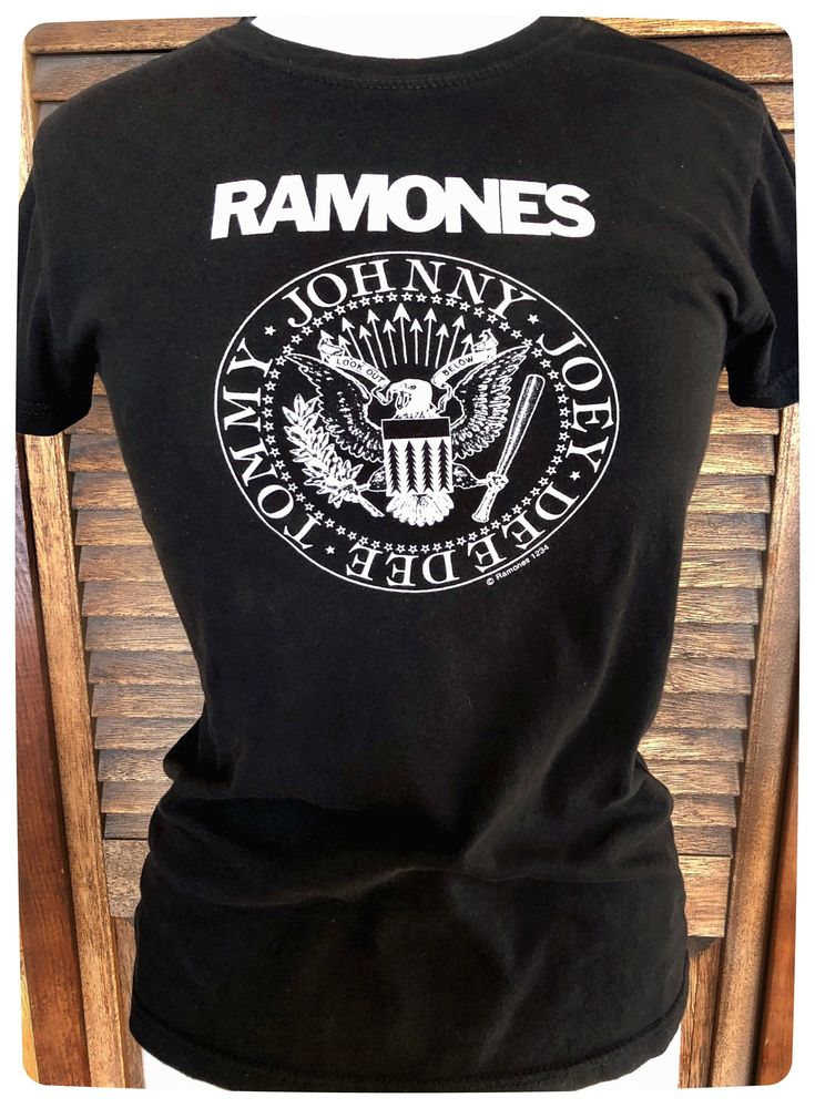 "Super cool Vintage RAMONES T Shirt in Black Ladies XS/Small. This Rock Merch tee from the classic American Punk Band is a must have for fan and / or collector! The art work designed by Arturo Vega has original \"Look out below\" which was only seen in earlier designs then switched to \"hey hey let's go\" and even later \"blizkrieg Bop\"   Most likely a reprint from the 90s or 2000s but still a very rare and hard to find shirt.  Good preloved condition. This shirt is super soft, slight fading and pilling from normal well loved wear and washing. No Stains. No Holes.  Brand: Ramones 1-2-3-4 Size: Ladies Small (slim fit)  Pit to Pit 18\" Centre Back to Hem 23 1/4\" 100% Cotton all shipping has is insurances and tracked. *all international sales may be subject to duties and/or taxes when  ente Rock Style Band Logo T-shirt With Crew Neck, Rock Style Cotton T-shirt With Logo Print, Punk Style T-shirt For Music Festivals, Band Logo Tops For Alternative Fashion With Crew Neck, Unisex Punk Band Logo Tops, Rock Style T-shirt With Logo For Concerts, Unisex Black Rock T-shirt, Punk T-shirt With Front Print For Concert, Punk T-shirt With Front Print For Alternative Fashion