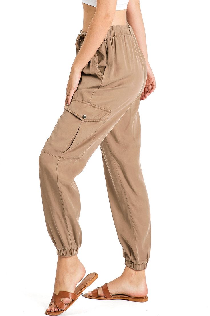 Light weight jogger pants with a high rise fit, a stretchy waist and an adjustable drawstring. Pockets at the sides and oversized pockets down the leg. Tapered elasticized ankle length. Baggy and comfortably fit. CARE | Hand Wash ColdCONTENTS | 100% Tencel MEASUREMENTS | 38"/97 cm Top to Bottom 26"/66 cm Inseam 12"/31 cm Rise (Size Small) MODEL | 5'8 - wearing a size SmallIMPORTED Sporty Joggers With Cuffed Ankles, Relaxed Fit Cargo Style Joggers For Loungewear, Utility Relaxed Fit Joggers For Loungewear, Fall Utility Joggers With Relaxed Fit, Relaxed Fit Utility Joggers For Loungewear, Spring Utility Joggers With Elastic Waistband, Spring Cargo Style Relaxed Fit Joggers, Spring Athleisure Cargo Joggers, Spring Athleisure Cargo Style Joggers