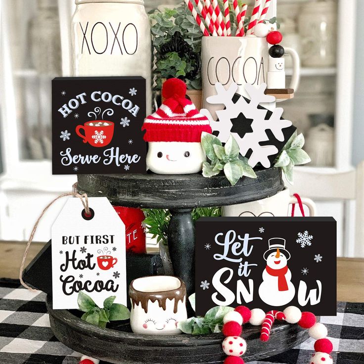 a christmas tree with coffee mugs and candy canes on it's top