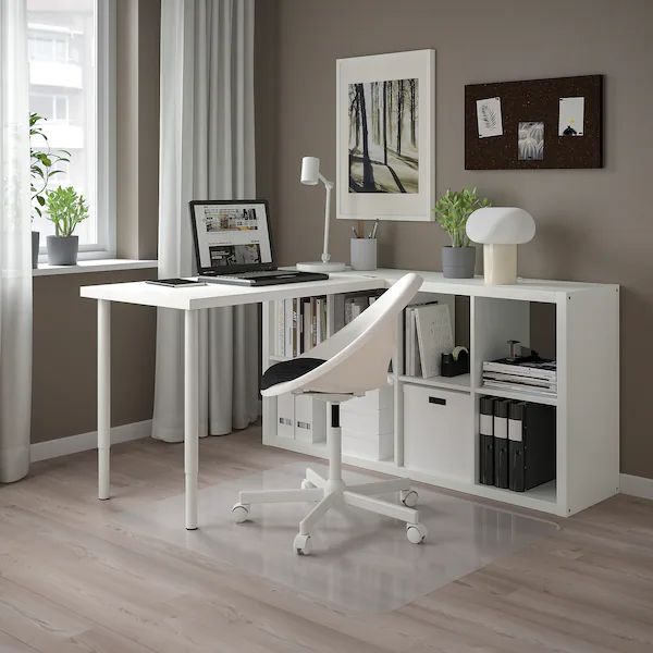 a white desk with a laptop computer on top of it next to a book shelf