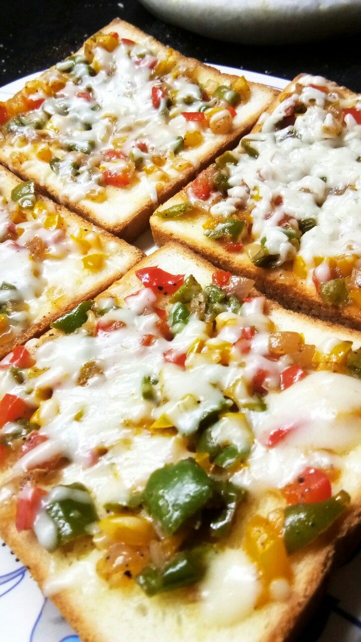 four slices of pizza sitting on top of a blue and white plate