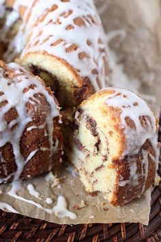 a bundt cake with white icing sitting in a basket