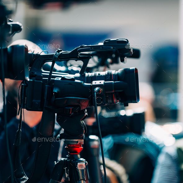 the camera is set up on top of a tripod in front of other cameras