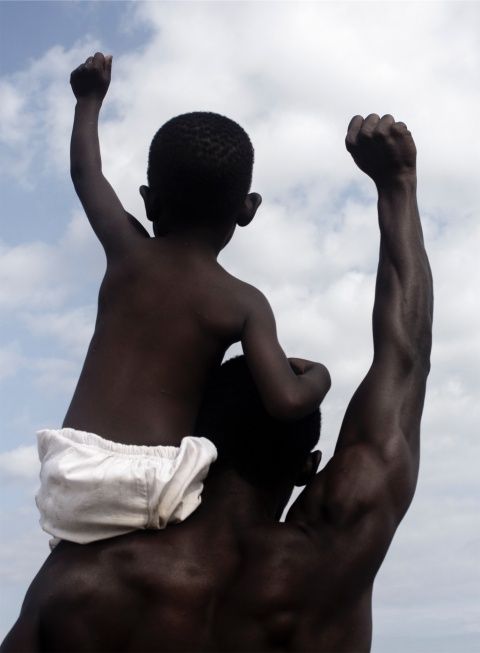 a man holding a child up in the air