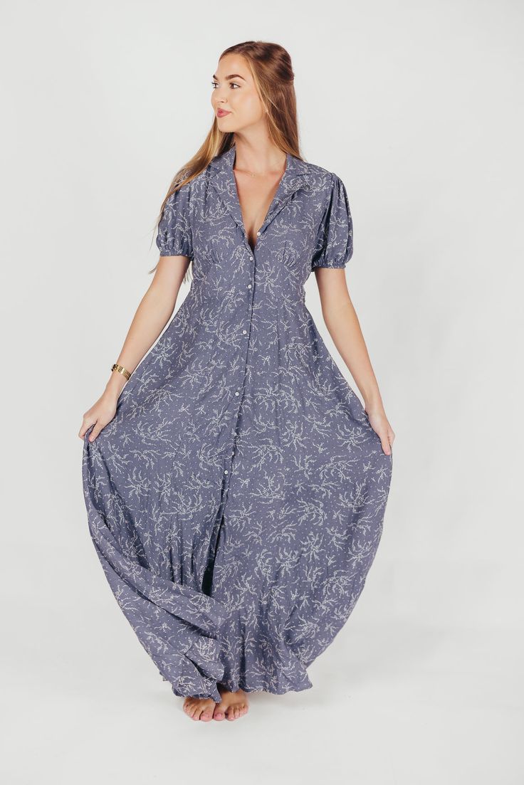 This gorgeous, feminine maxi is the easiest thing to wear for summer holidays and backyard barbeques. We love its lightweight ease and elegant floral pattern, and its front button placket gives it a classic quality you'll love wearing year after year. Available in two colorways. FIT: Runs true to size. MATERIAL: Viscose. GARMENT DETAILS: Lightweight floral maxi dress with a full front button placket, collared V-neckline, and short sleeves. Features a pleated front, in-seam pockets, and lining. S Spring Beach Button-up Maxi Dress, Summer Button-up Maxi Dress For Beach, Flowy Spring Maxi Dress With Button Closure, Summer Button-up Maxi Dress With Buttons, Summer Button-up Maxi Dress, Short Sleeve Maxi Dress With Buttons For Summer, Maxi Length Button Dresses For Garden Party, Chic Buttoned Maxi Dress For Garden Party, Maxi Length Dresses With Buttons For Garden Party