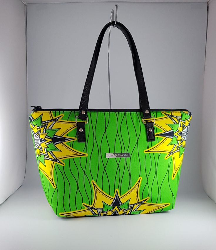 "\"Bag description:  This lovely bag is a perfect size for any occasion, with ample room for all your essentials when shopping, going to the office or on an evening out. Brighten up your day with this green and yellow vibrant bag and change the mood around you.   This tote bag is a combination of Ankara African fabric and faux leather, fully lined waterproof canvas fabrics. The handles are long enough to fit comfortably on the shoulder or held by hand. Internally, this bag is fully lined with waterproof canvas and zippered pocket which fits your phone or other valuables. This bag is closed with a durable zip. Bag Style: Tote Fabric: African Wax Print Fabric - Ankara green and yellow print fabric. 100% Cotton Lining: Waterproof canvas Hardware: Chrome  Handles: 24 inches in black faux leath Green Hobo Bag With Zipper Closure For On-the-go, Green Hobo Bag With Adjustable Strap For On-the-go, Green Box Bag With Double Handle, Green Bucket Bag With Top Carry Handle, Trendy Green Pouch Bucket Bag, Green Handheld Bucket Bag With Adjustable Strap, Green Double Handle Bag With Top Carry Handle, Green Satchel Box Bag With Top Carry Handle, Trendy Green Large Capacity Bag