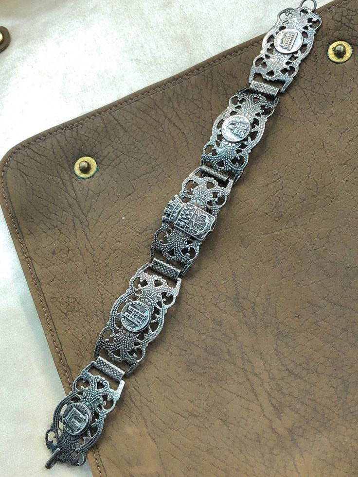 "Antique Art Deco Silver bracelet Souvenir of Paris France Elaborate silver panels featuring landmarks of Paris Arc de Triomphe, Notre Dame, Monmarte, + River Seine Highly detailed embossed repousse details Circa 1920s measures: 7 1/4\" length, fits average size wrist. Very good original antique condition. Please ask questions before purchasing, all sales are final." Traditional Silver Bracelet With Sterling Clasp, Vintage Engraved Antique Silver Sterling Bracelet, Collectible Sterling Silver Antique Bracelet, Engraved Antique Silver Sterling Bracelet In Vintage Style, Vintage Engraved Sterling Silver Bracelet In Antique Silver, Antique Silver Bracelet Gift, Victorian Engraved Metal Bracelets, Victorian Hallmarked Silver Bracelets, Victorian Hallmarked Silver Bracelet