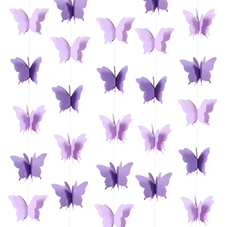 purple butterflies hanging from strings on a white background