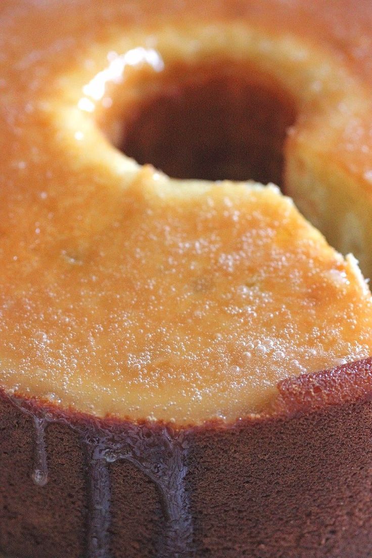 a close up of a cake on a plate with syrup drizzled over it