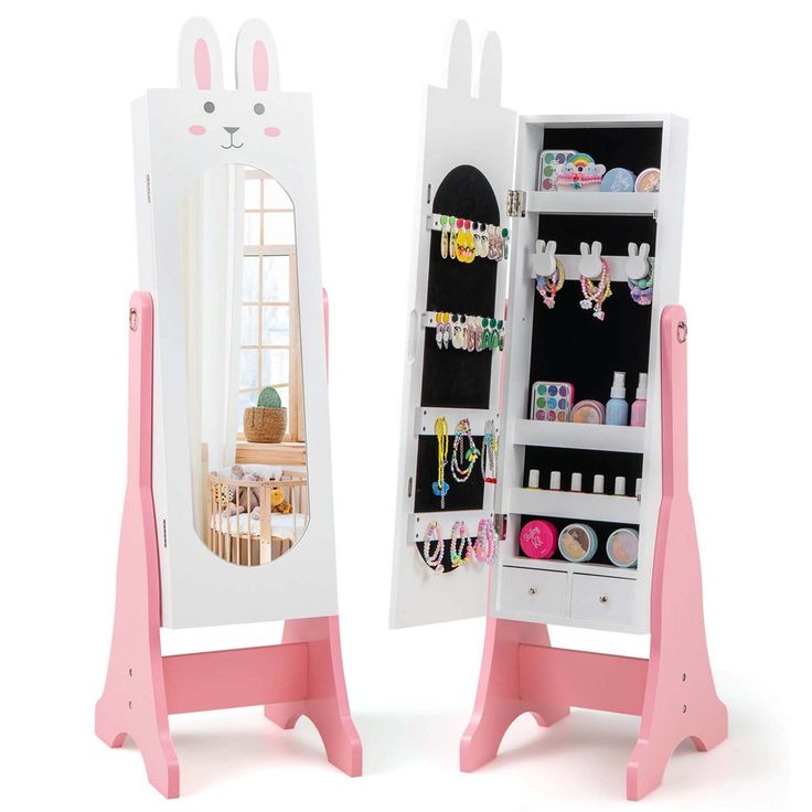 a pink and white wooden doll's dressing table with a mirror on the door