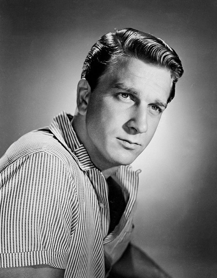 an old black and white photo of a man wearing a striped shirt with a bow tie