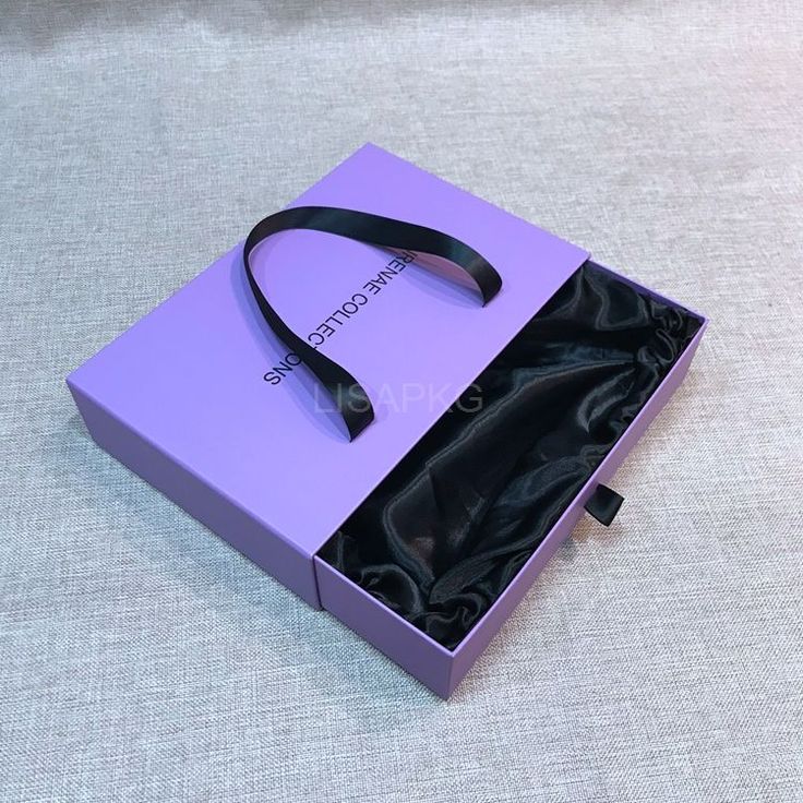 an open purple box with a pair of black headphones in it