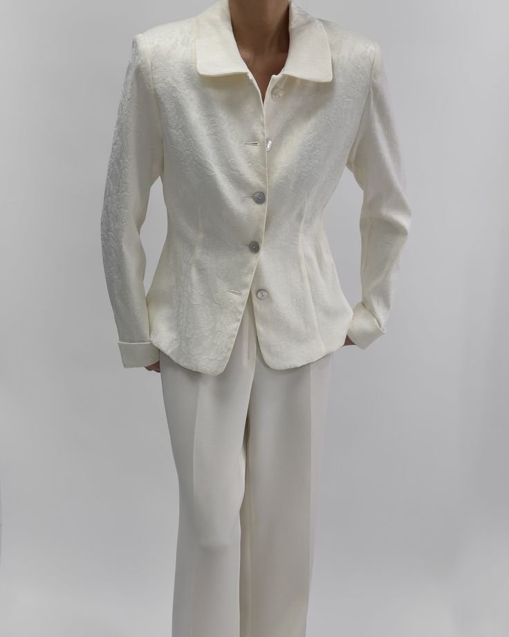 Classic and elegant Hennes Collection vintage blazer in cream-white. Features long sleeves, front buttons, no pockets. Flower pattern with padded shoulders from 2000s. In excellent vintage condition. Material: Outer- 55% polyester, 42% cotton, 3% elastaan/ Lining- 100% acetate Recommed Fit: M - see measurments.    Size Tag Reads: 42 Measurments Laid Flat: Length: 63cm, 24,8" Chest: 100cm, 39,3" Sleeve: 63cm, 24,8" Styled on 5.7 ft (172 cm), usually dressed in size S. Please know all pieces are v Classic Cream Single-breasted Blazer, Classic Cream Blazer With Button Closure, Cream Blazer With Button Cuffs For Spring, Spring Cream Blazer With Button Cuffs, Cream Semi-formal Blazer For Spring, Cream Blazer For Semi-formal Spring Events, Classic Tailored Cream Blazer, Classic Cream Blazer With Buttons, Classic Long Sleeve Blazer With Covered Buttons