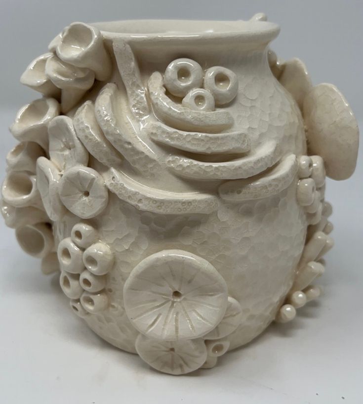 a white vase with an animal design on it