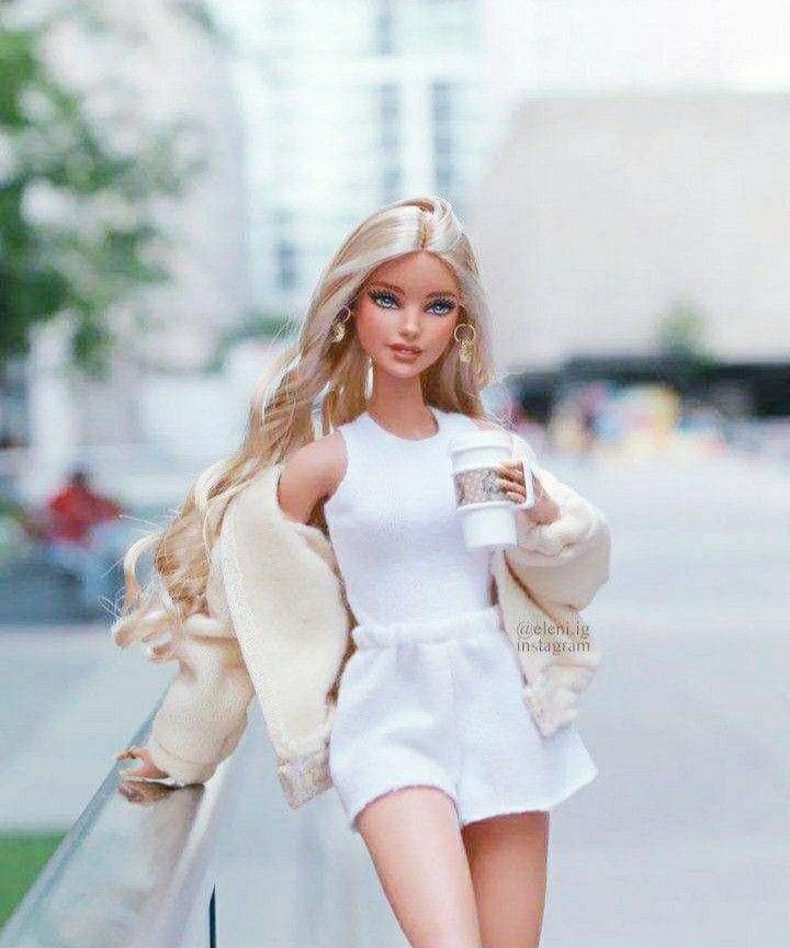 a barbie doll walking down the street with a coffee cup in her hand and jacket over her shoulder