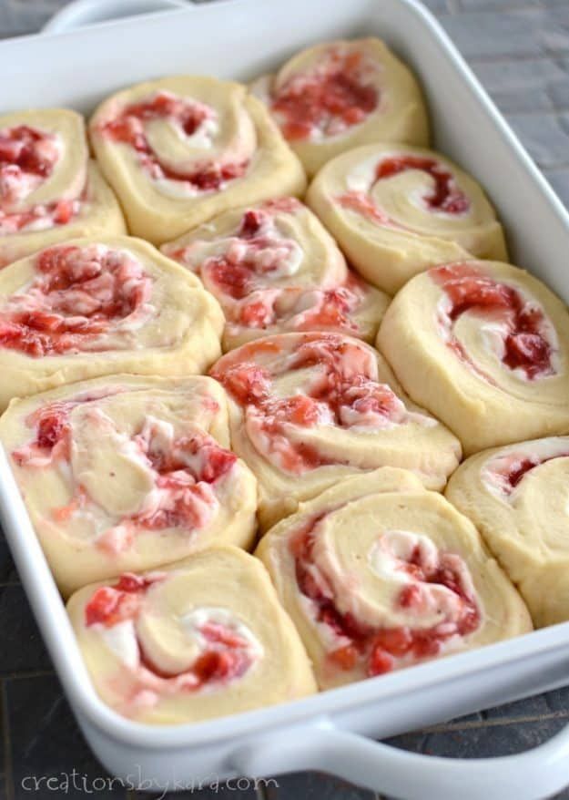 rolls with cream cheese and strawberries in a white casserole dish