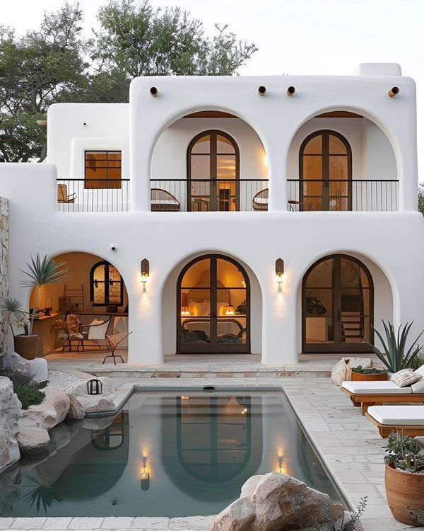 a large white house with an outdoor pool