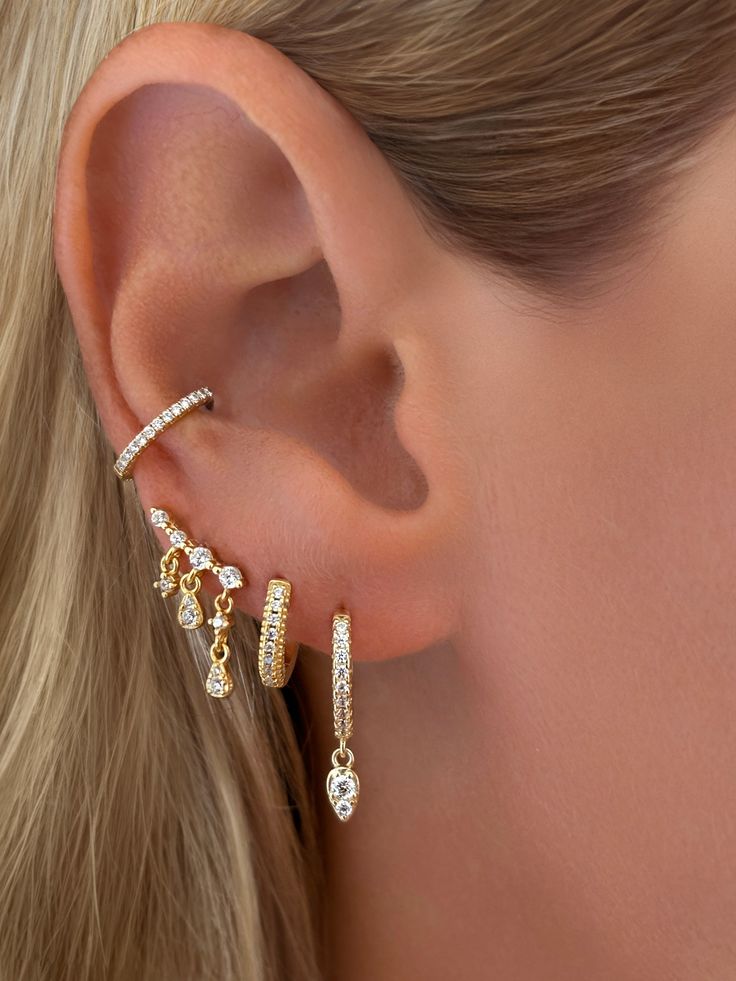 A unique and beautiful statement piece. Whether you're wearing this stunning earring alone or stacked- it's sure to stand out. Styled on our founder, Emily withFine White Topaz Dangle Chain Stud EarringsVermeil Triple Row Pavé CZ HuggieVermeil Teardrop Dangle Huggie Earrings Size: Length: Longest Drop 13mm ( approximately 1/2 inch)Stone: Cubic ZirconiaMaterials: Sterling Silver & 14K Gold Vermeil Dangle Ear Cuff With Matching Earrings For Everyday, Everyday Dangle Ear Cuff With Matching Earrings, Elegant 14k Gold Dangle Cartilage Earrings, Dainty Dangle Ear Cuff, Yellow Gold Dangle Ear Cuff, 14k Gold Dangle Jewelry With Matching Earrings, 14k Gold Dangle Earrings With Matching Set, Yellow Gold Dangle Ear Cuff For Pierced Ears, Elegant Matching Dangle Cartilage Earrings