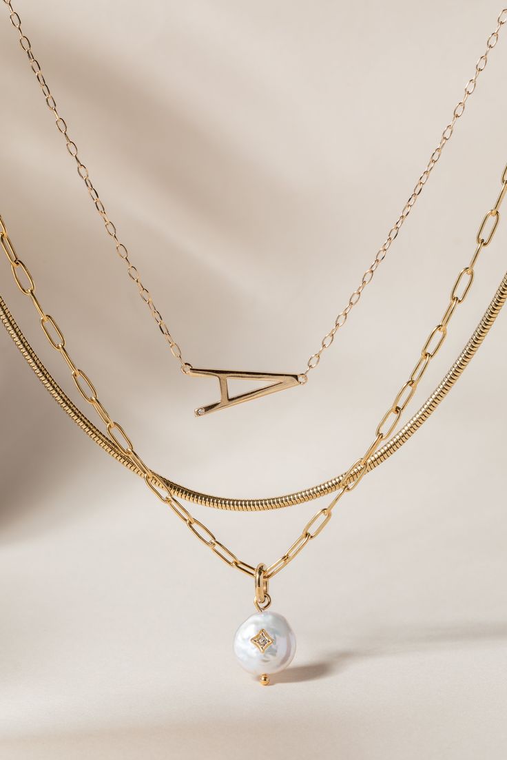 Layered looks are trending, and the luxurious Precious Elongated Initial Necklace is the perfect personal touch to your neck stack. This letter necklace is brilliantly crafted with a 14K gold-plated sterling silver chain and an elongated initial letter uniquely strung sideways. Whether you choose to wear your own initial or that of a cherished loved one, this necklace is a timeless piece that keeps your most treasured connections beautifully close to your heart. Gold Initial Necklace With Paperclip Chain For Everyday, Gold Minimalist Initial Necklace With Paperclip Chain, Minimalist Gold Initial Necklace With Paperclip Chain, Elegant Gold Name Necklace With Cable Chain, Gold Sterling Silver Initial Necklace With Cable Chain, Elegant Everyday Initial Necklace With Paperclip Chain, Elegant Tarnish-resistant Initial Necklace For Anniversary, Luxury Delicate Chain Necklaces For Layering, Elegant Initial Pendant Necklace With Paperclip Chain