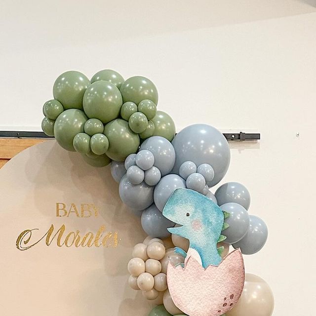 balloons are arranged in the shape of animals and birds on a sign that says baby shower