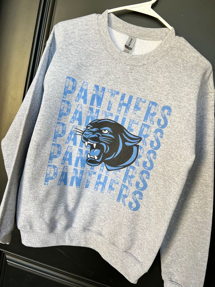 It's sweatshirt season! Cheer on the Panthers in this comfy Unisex Game Day sweatshirt available in sizes S-2X.  Each sweatshirt is printed in-house by me ensuring high quality.   Note: As each sweatshirt is individually printed, slight variations in color and placement may occur, adding to the uniqueness and charm of your Falcons Sweatshirt Available in Grey, Carolina, and White Color shown: grey Cotton Logo Print Sweatshirt For Game Day, Gray Letter Print Sweatshirt For Fan Gear, Cotton Sweatshirt With Logo Print For Game Day, Fall Fan Merchandise Sweatshirt With Text Print, Team Spirit Cotton Sweatshirt With Screen Print, Fan Apparel Sweatshirt With Logo Print In Relaxed Fit, Relaxed Fit Fan Apparel Sweatshirt With Logo, Relaxed Fit Logo Print Sweatshirt Fan Apparel, Game Day Gray Letter Print Sweatshirt