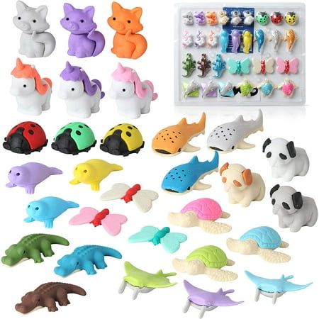 a bunch of toys that are sitting on a white surface and in the shape of animals