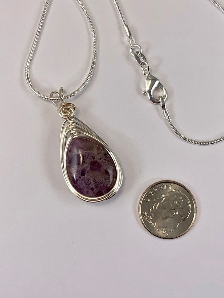 This beautiful natural amethyst necklace is simple yet elegant. The silver wire wrapped design enhances the natural beauty of the smooth polished stone without over powering it. I simply love this gemstone for its natural beauty. Your necklace comes with a sleek 1mm sterling Silver plated chain in your choice of length. Pair this flattering necklace with your favorite dress or a pair of jeans, the possibilities are endless. Amethyst is also the birthstone for February, making this a great gift. Natural Stone Necklace, Natural Stones Necklace, Birthstone Gifts, February Birthstone, Amethyst Necklace, Amethyst Pendant, February Birth Stone, Pendant Silver, Favorite Dress