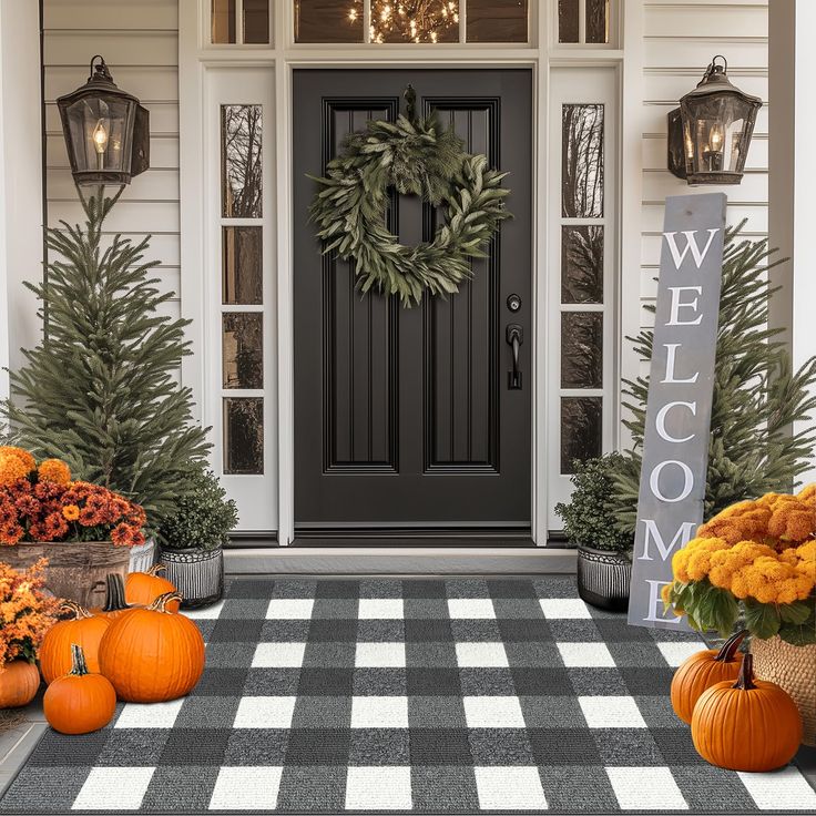 front porch decorated for fall with pumpkins and flowers