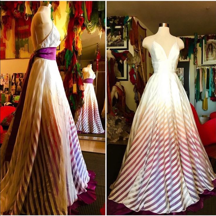 two dresses on mannequins in front of a mirror, one with purple and white stripes