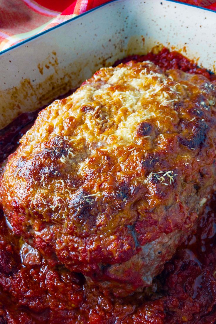 meatloaf with sauce in a white casserole dish