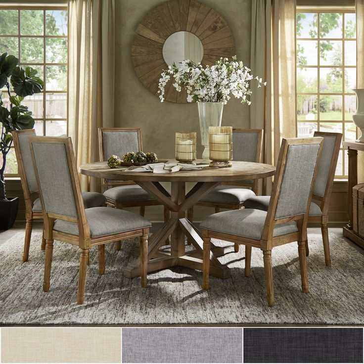 the dining room table is surrounded by gray chairs and beige upholstered walls with windows