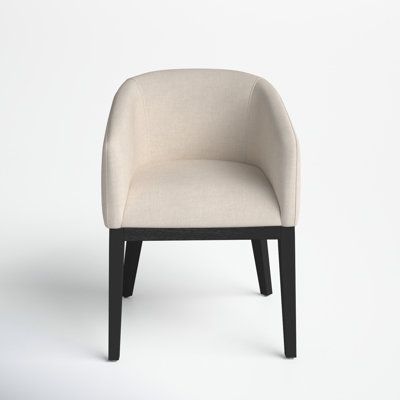 a white chair sitting on top of a white floor next to a black leg rest