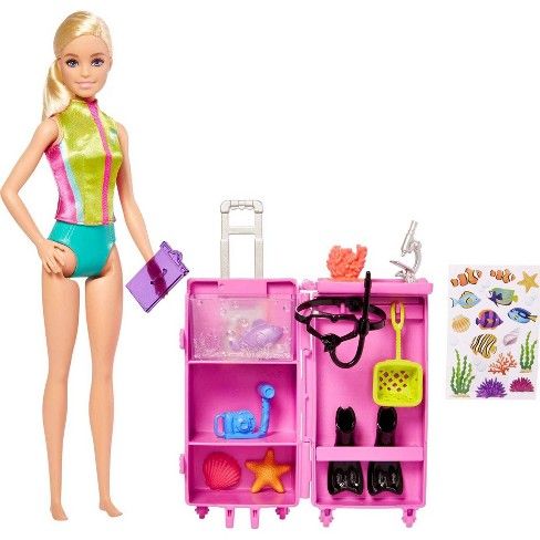 a barbie doll standing next to a pink toy case