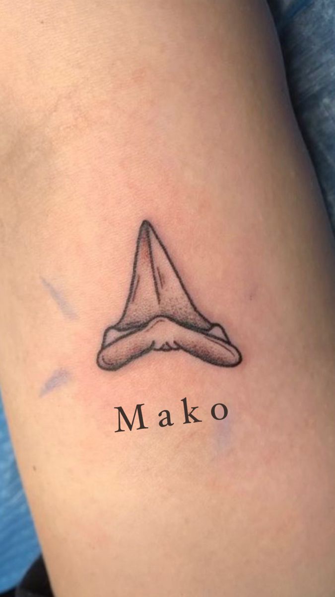 a tattoo with the word mako on it's side and a hat in the middle