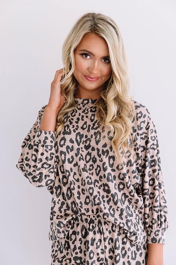 Stay wild on the weekend in our adorable mocha colored "All For Love" top featuring soft lightweight material patterned with a bold black leopard print, a high rounded neckline, loose 3/4-length sleeves with fitted cuffs, a wrapped back with an oversized cutout, and a relaxed silhouette that falls into a rounded hemline! This comfy piece styles perfectly with our matching "Cozier Now Leopard Joggers in Mocha," a scrunchie, and some fuzzy slippers for the ultimate two piece lounge look! Oversized Leopard Print Top, Oversized Leopard Print Tops With Long Sleeves, All For Love, Lounge Looks, Leopard Top, Black Leopard Print, Fuzzy Slippers, Impressions Online Boutique, Stay Wild