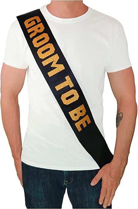 a man wearing a white t - shirt with the word groom to be on it