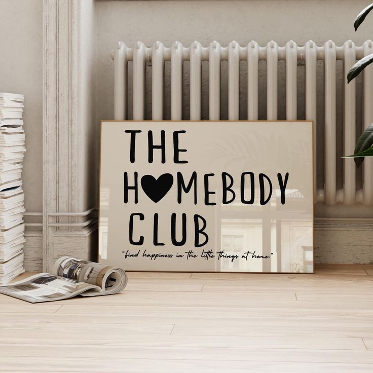 a sign that says the homeboy club next to a stack of newspapers and a potted plant