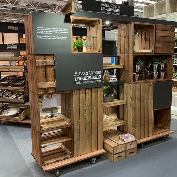 an exhibit booth with wooden crates and shelves