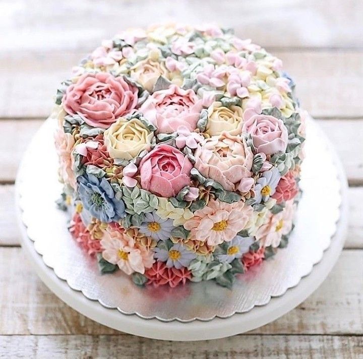 a cake decorated with flowers on top of a white plate