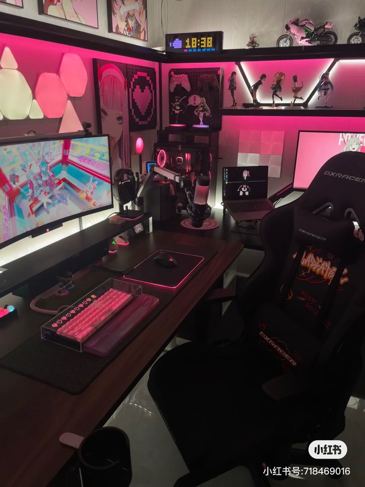 a computer desk with two monitors, keyboard and mouse on it in front of pink lighting